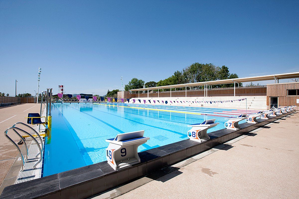 The outdoor 50-metre pool of the Grand Bleu aquatics centre in Cannes La Bocca under a blue sky