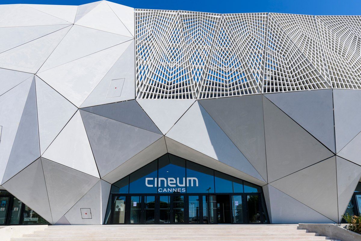 The faceted white façade of the Cineum cinema by Rudy Ricciotti in Cannes La Bocca