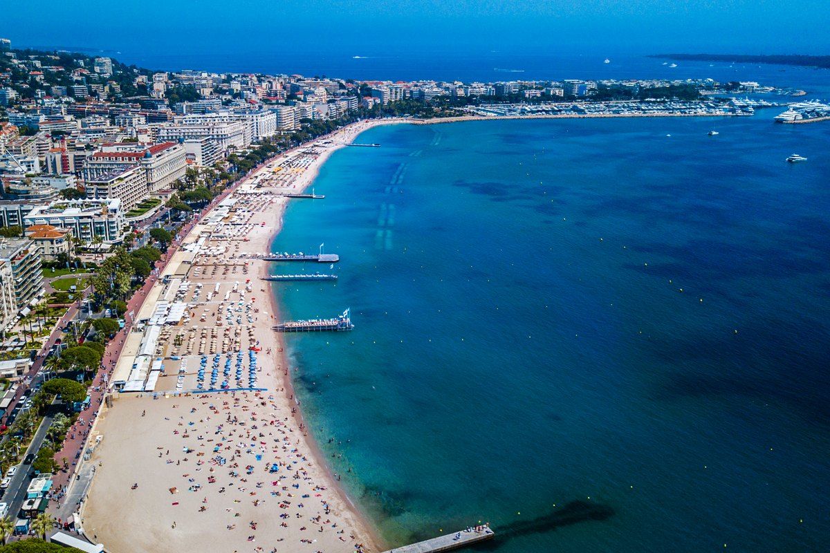 Aerial view of the Croisette in Cannes, its beaches and jetties curving along the bay