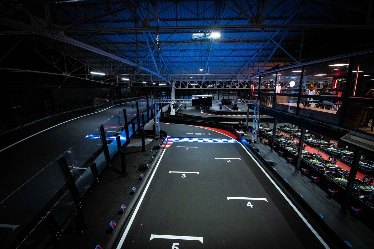 The two-level indoor electric kart track at Cannes Karting, with its numbered starting grid