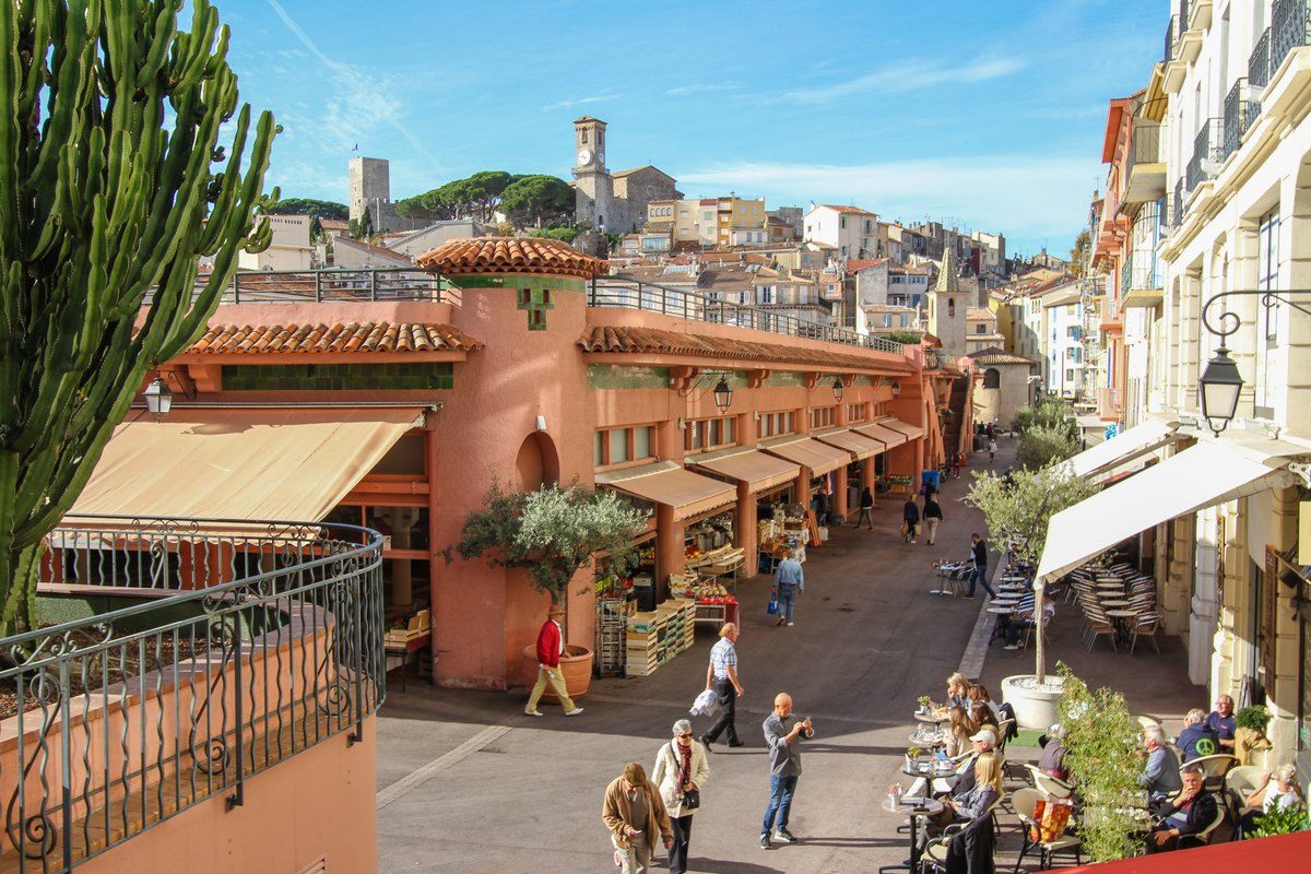 A street in Cannes climbing towards Le Suquet, with the Castre tower and church on the hill above