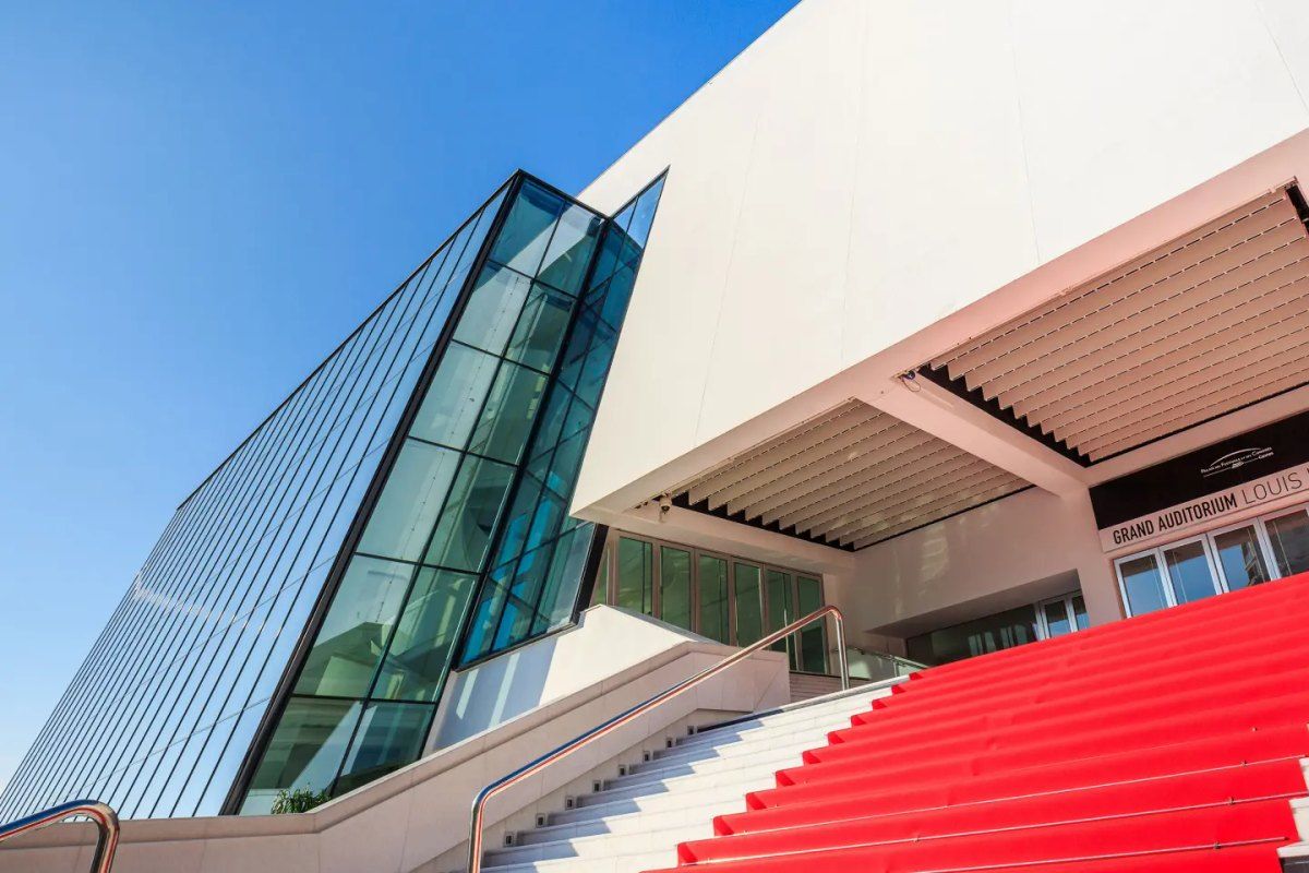 The red-carpeted steps of the Palais des Festivals in Cannes beneath its glass façade