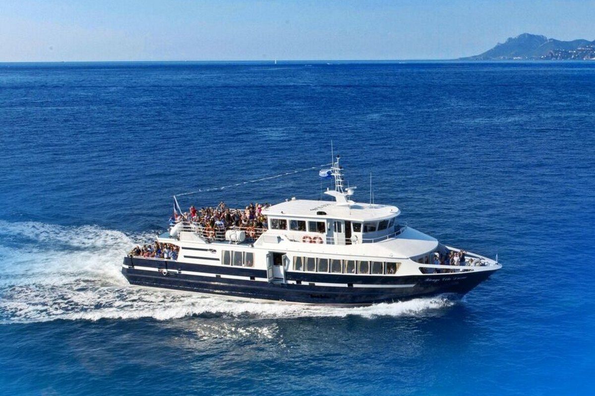 A Trans Côte d'Azur excursion boat at speed across the deep blue bay off Cannes