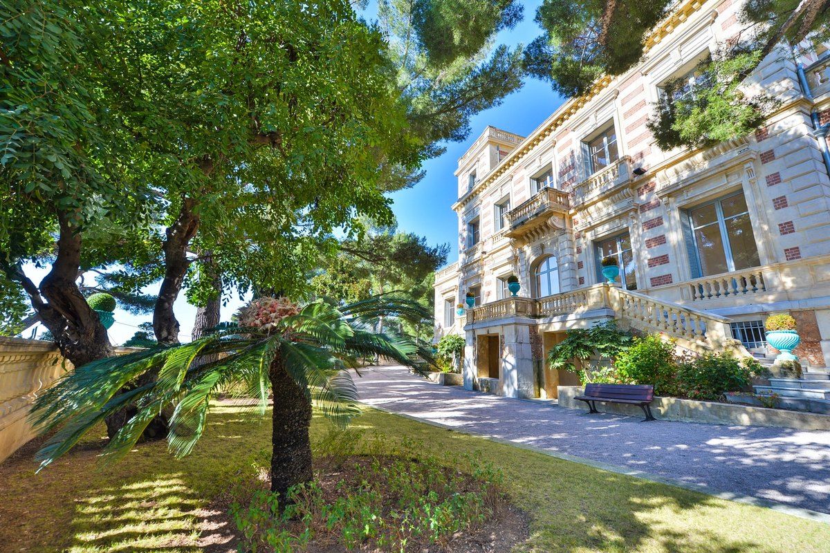 Palms and shady lawns in the park of the Belle Époque Château des Terrasses, Cap-d'Ail