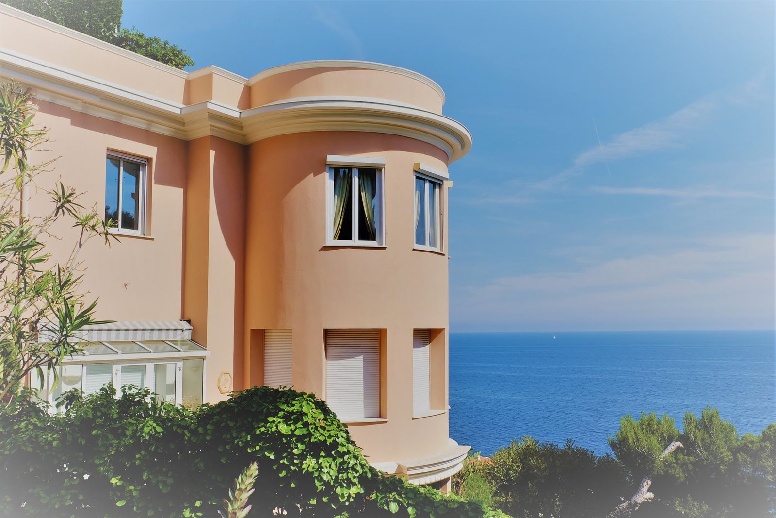 A pale villa with rounded balconies above the sea at Cap d'Ail