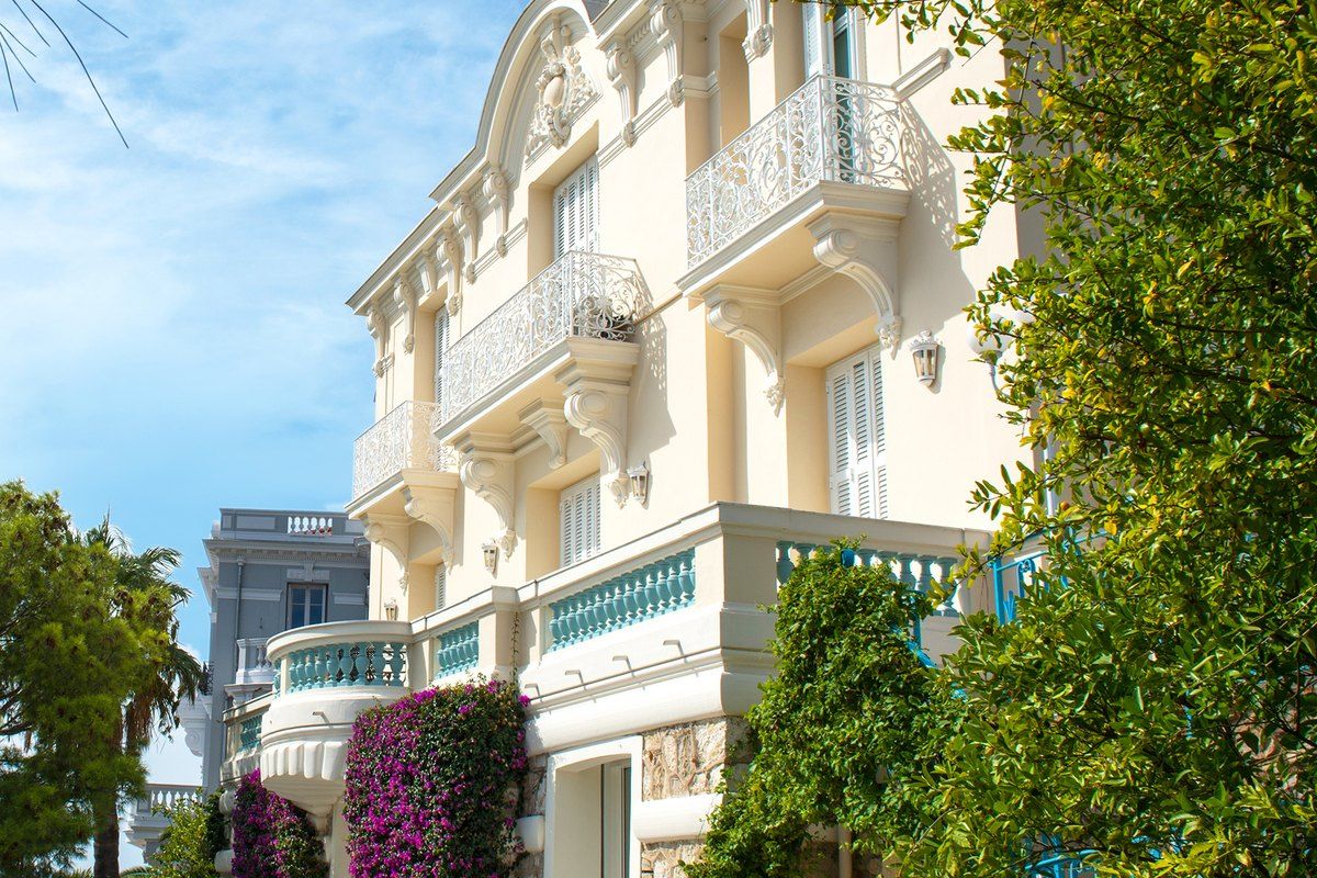 The cream Belle Époque façade and balconies of the Villa les Camélias museum in Cap-d'Ail