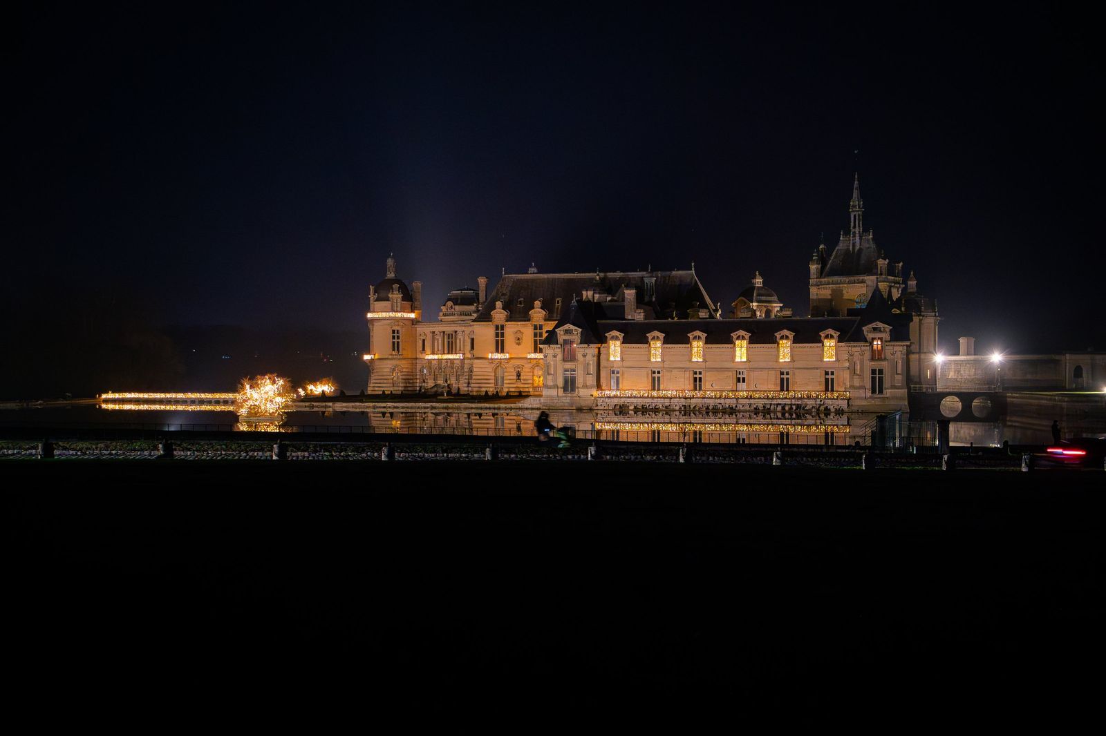 The Château de Chantilly lit up on a winter night