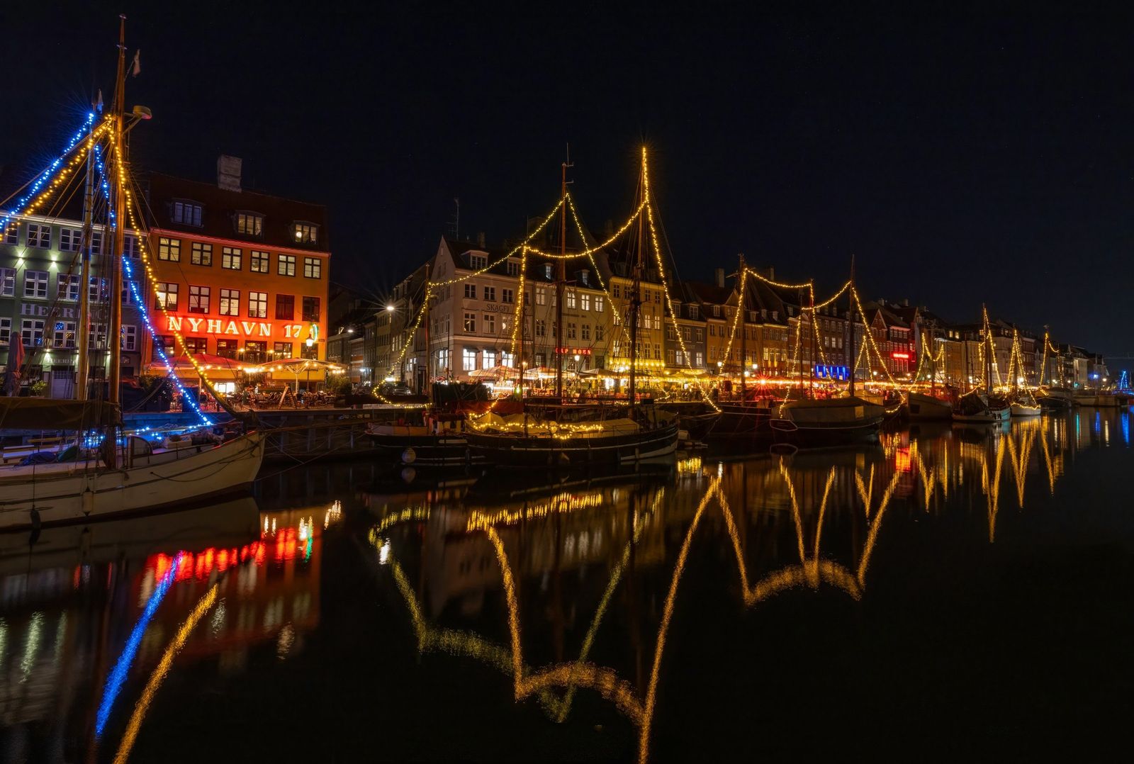 Nyhavn at night, its lights reflected in the water
