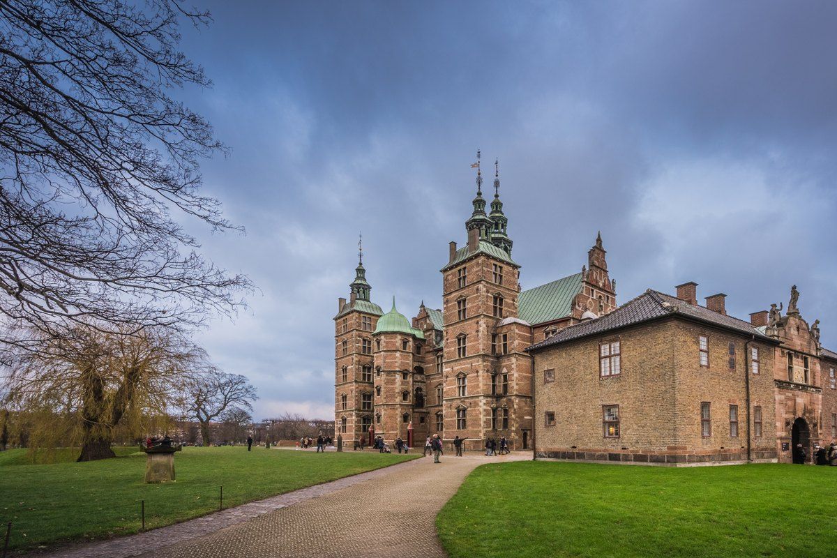 Rosenborg Castle's red-brick towers and spires behind the lawns of the King's Garden on an autumn day