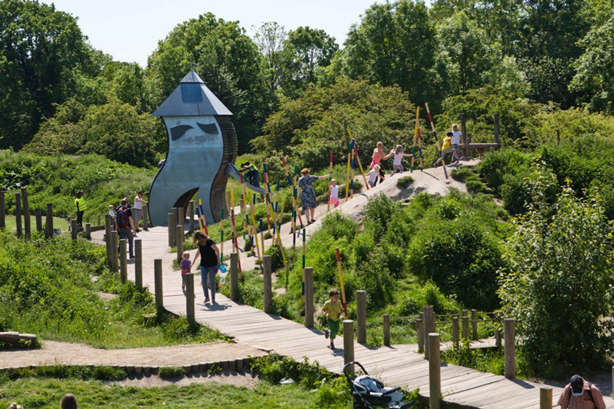Wooden boardwalks, wild planting and a tall play tower at the nature playground in Valbyparken