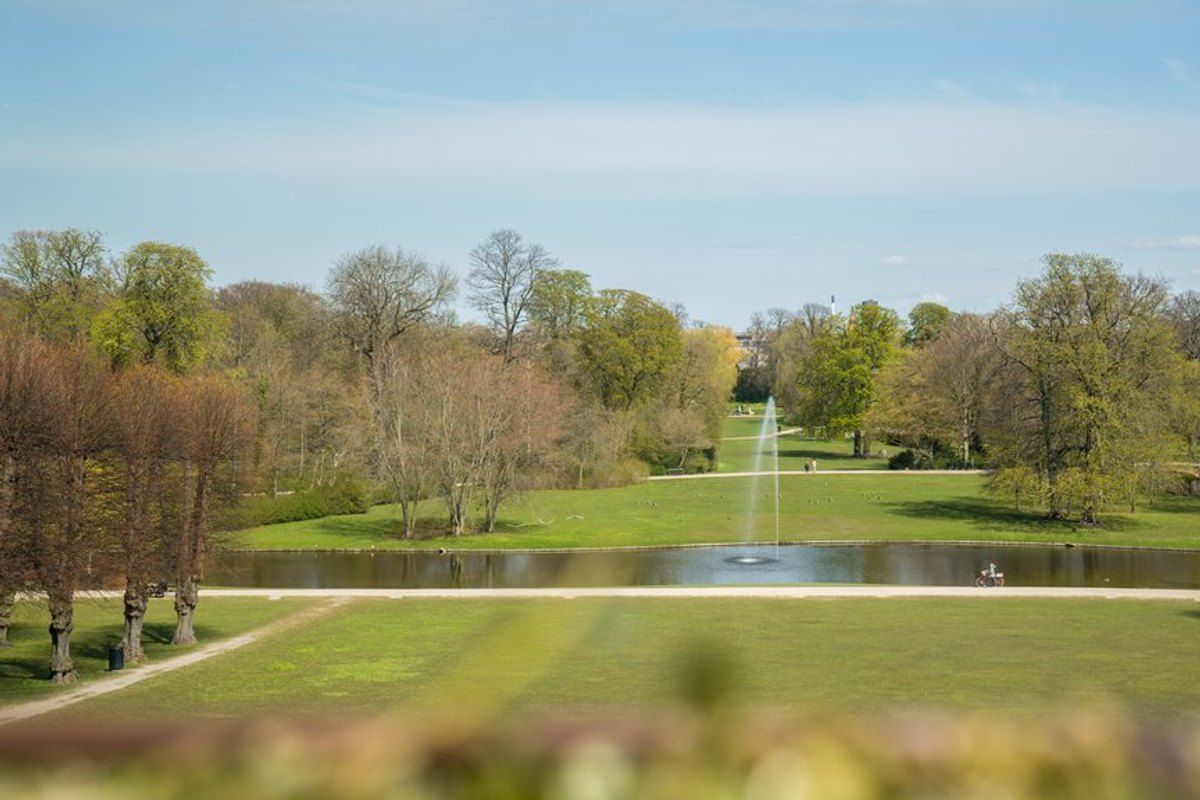 Lawns, old trees and a long canal with a fountain in Frederiksberg Gardens