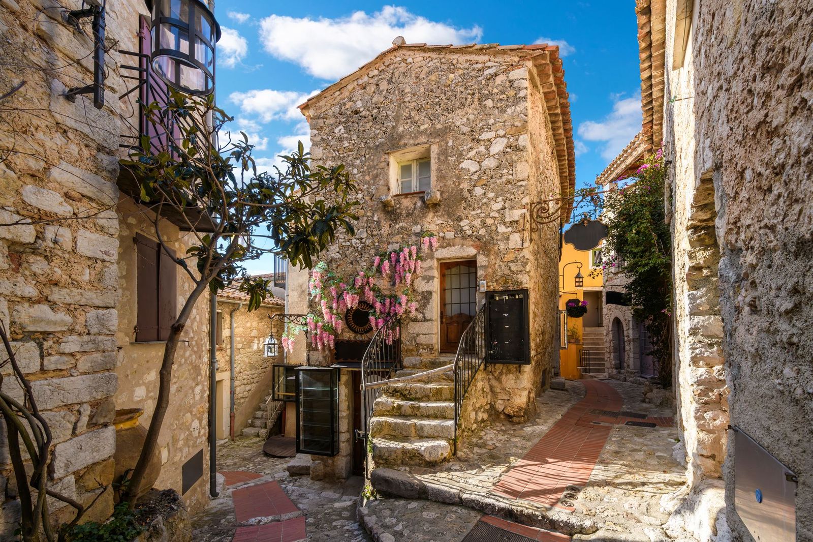 Narrow hillside alleys with shops and cafés in the village of Èze