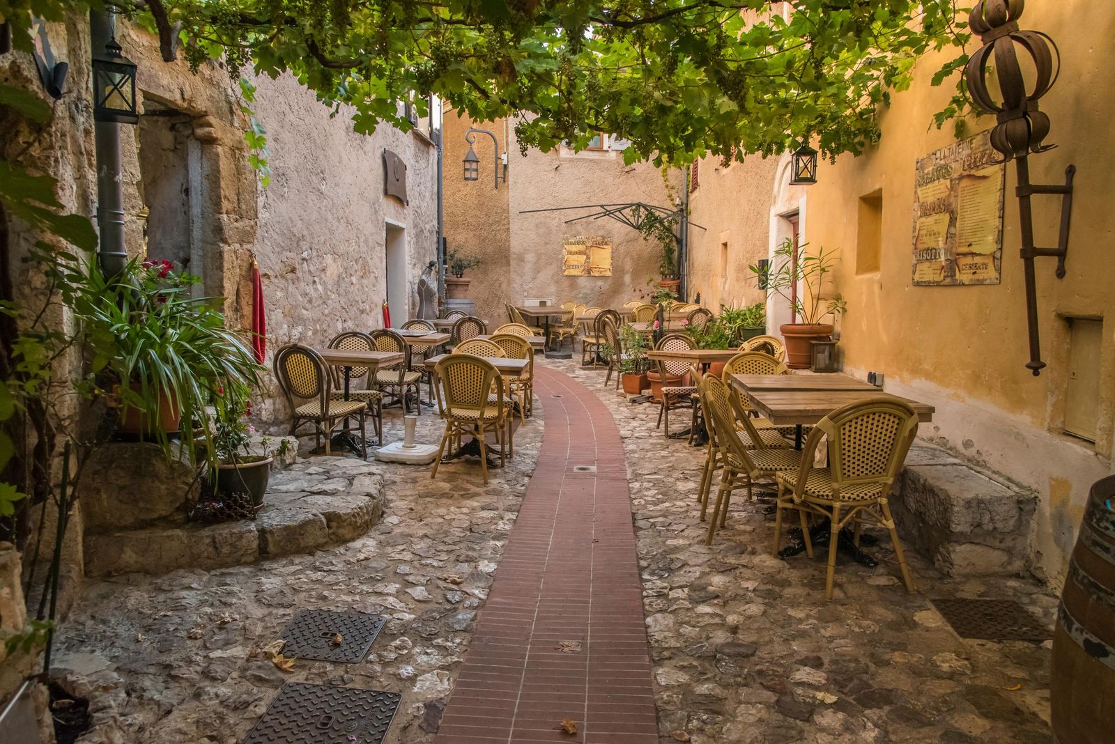 Restaurant tables in a street in Èze