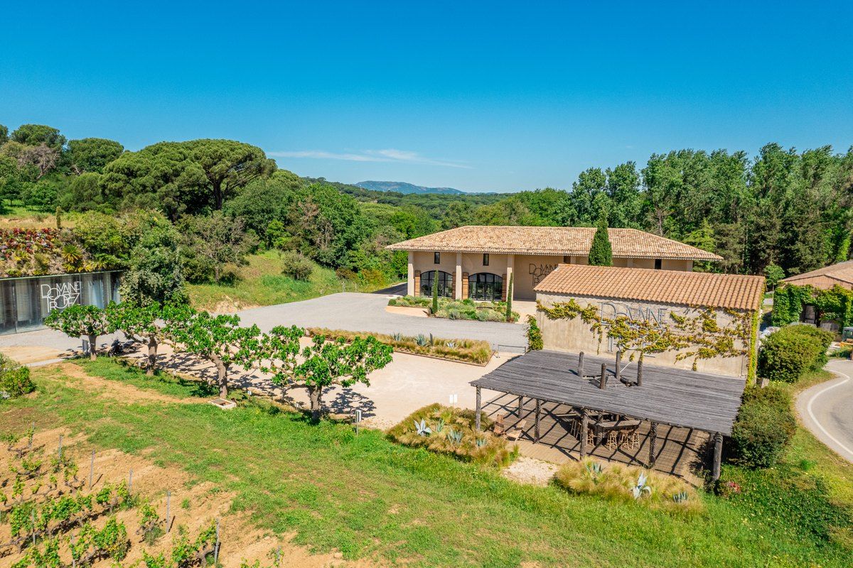 The Domaine Tropez estate buildings and tasting terrace among vines at Gassin