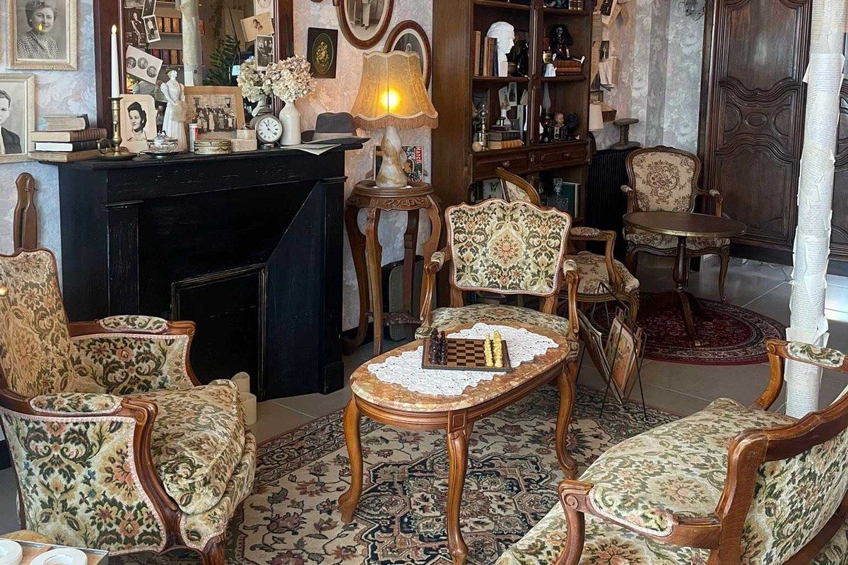 Tapestry armchairs, lamps and antiques in the tea room of Broc' & Délices, Vernon