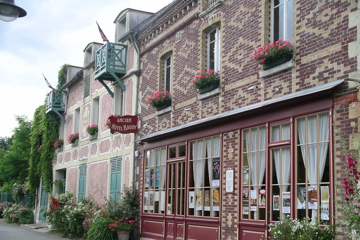 The brick and timber façade of the Ancien Hôtel Baudy on rue Claude Monet, Giverny