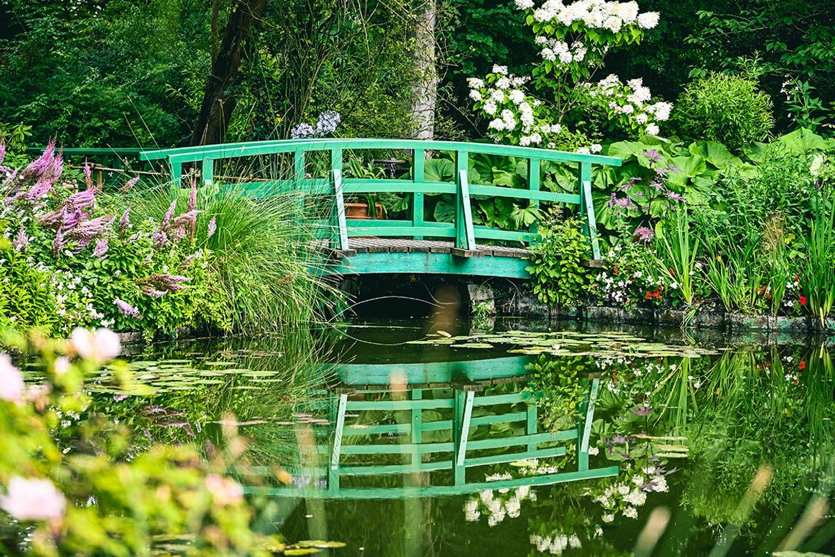 The green Japanese bridge over the water-lily pond in Claude Monet's garden at Giverny