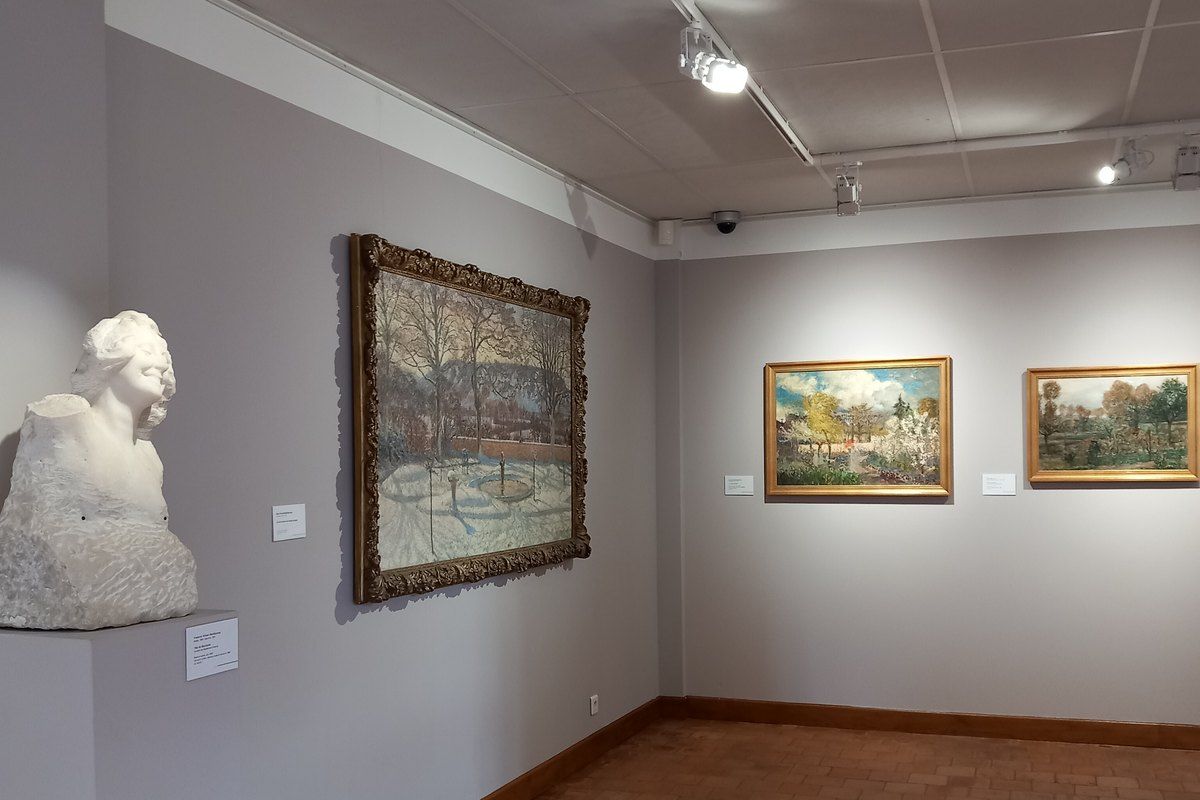 A marble bust and landscape paintings in a gallery of the Musée de Vernon