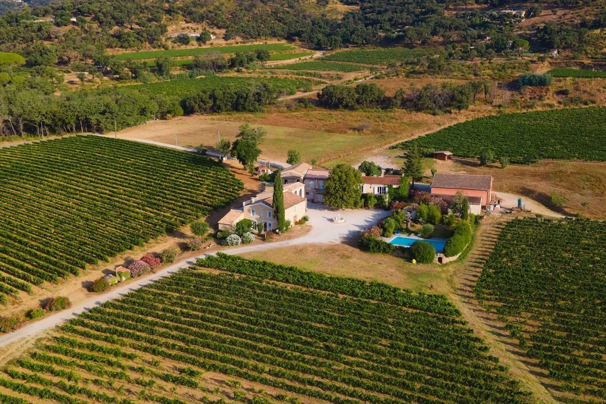 Aerial view of the vineyards and farmhouse of the Domaine du Val de Gilly at the foot of the Maures