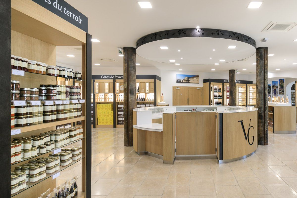 The shop of the Vignerons de Grimaud, with shelves of local produce and the round wine counter