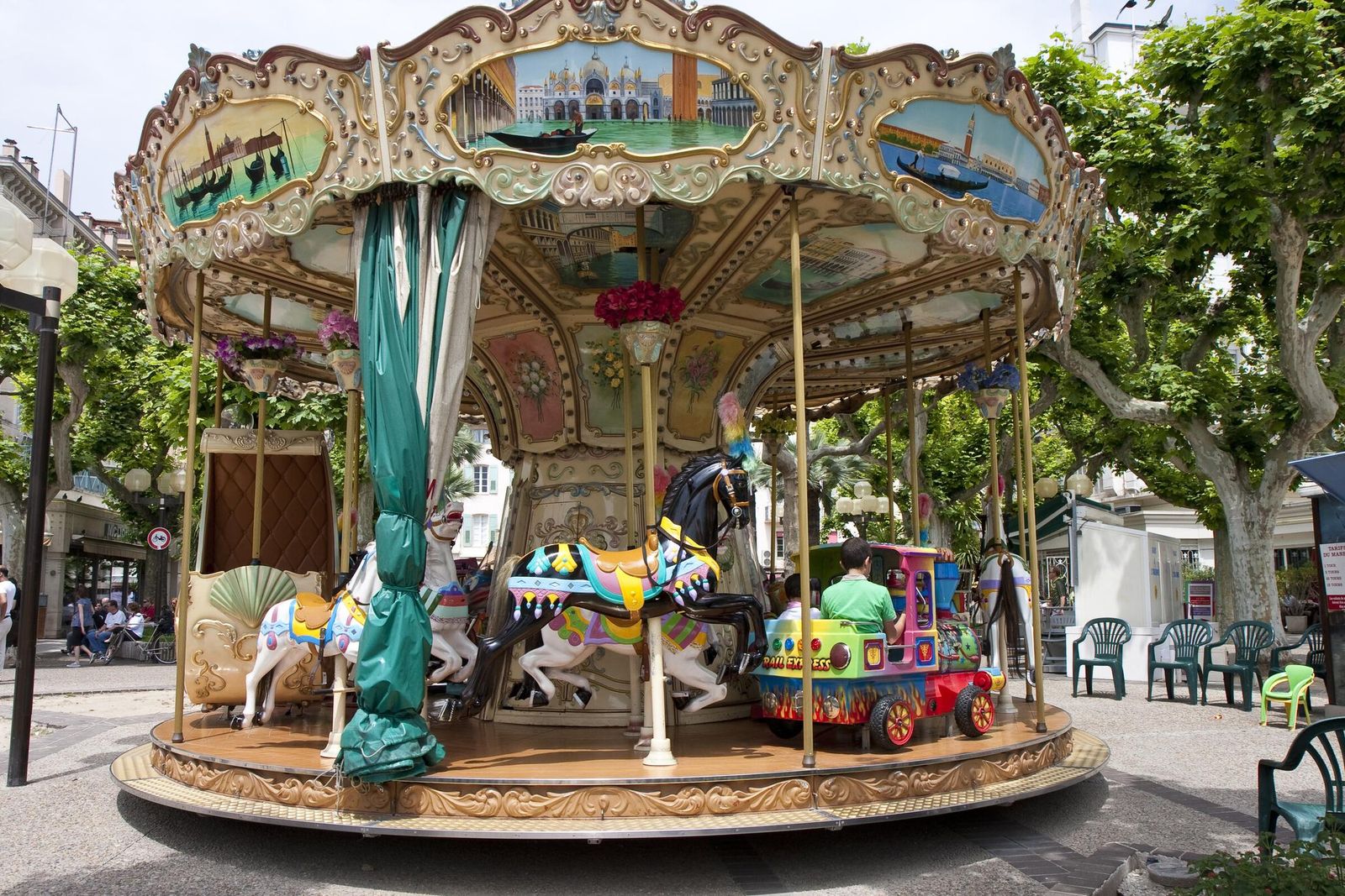 An old-fashioned painted carousel under the plane trees in Cannes, next door to Le Cannet