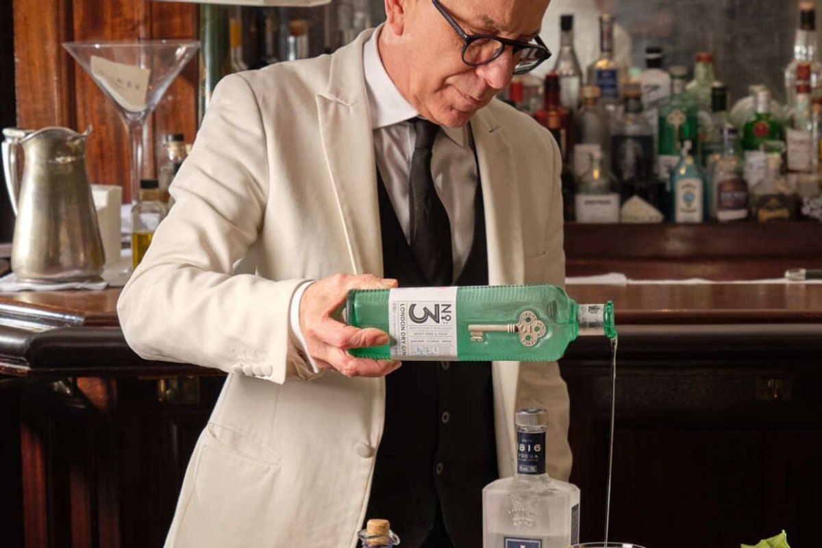 A bartender pouring an ice-cold martini at the trolley in Dukes Bar, St James's