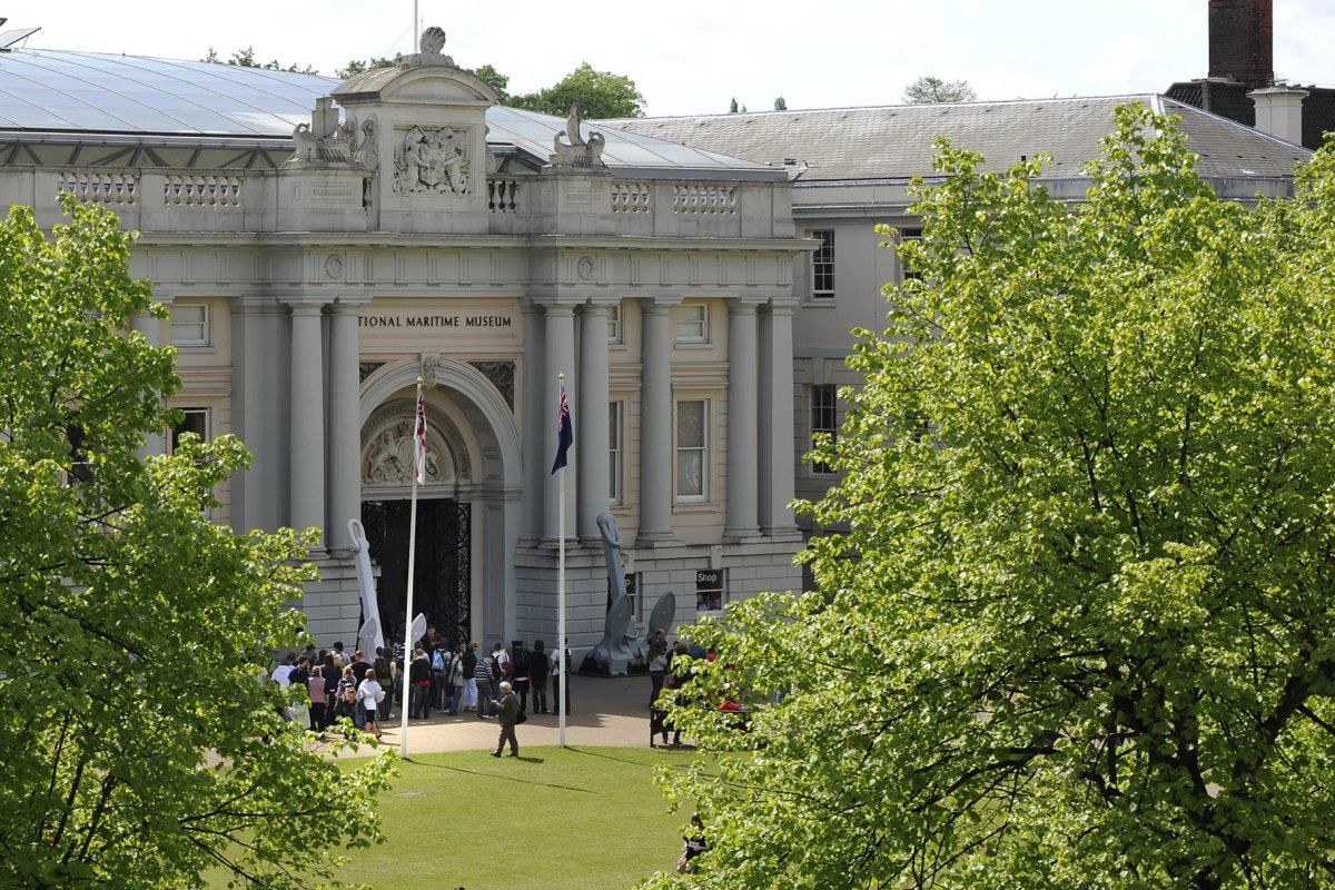 The colonnaded entrance of the National Maritime Museum in Greenwich, framed by trees