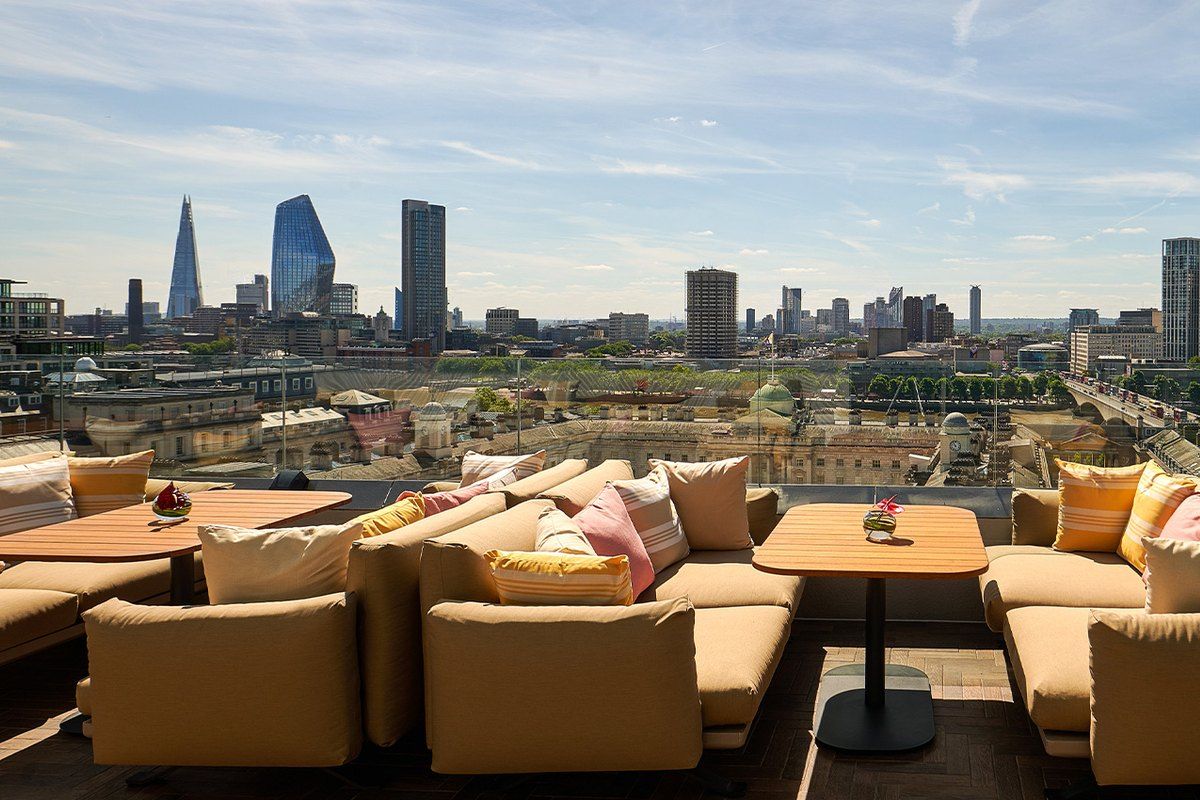 Sofas on the Radio Rooftop terrace at ME London looking east to the Shard and the City