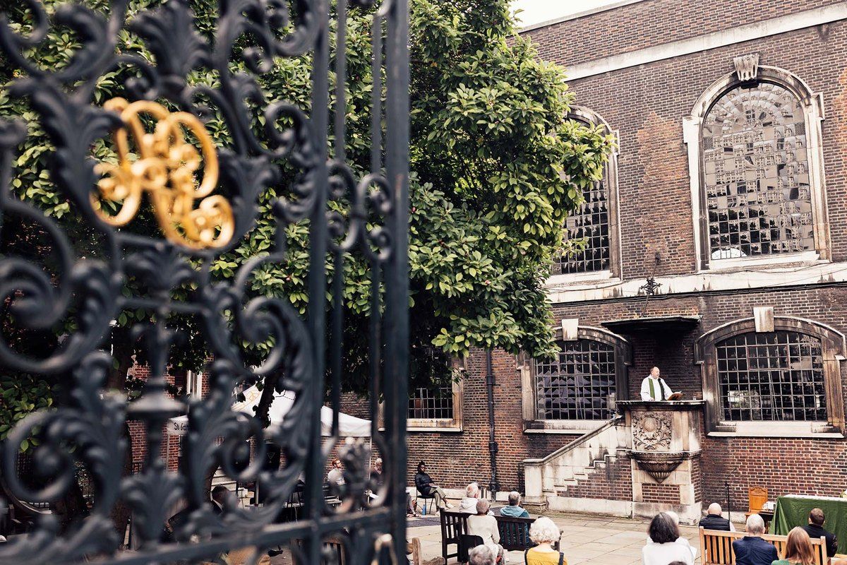 The wrought-iron gates and brick façade of St James's Church on Piccadilly, with its courtyard behind