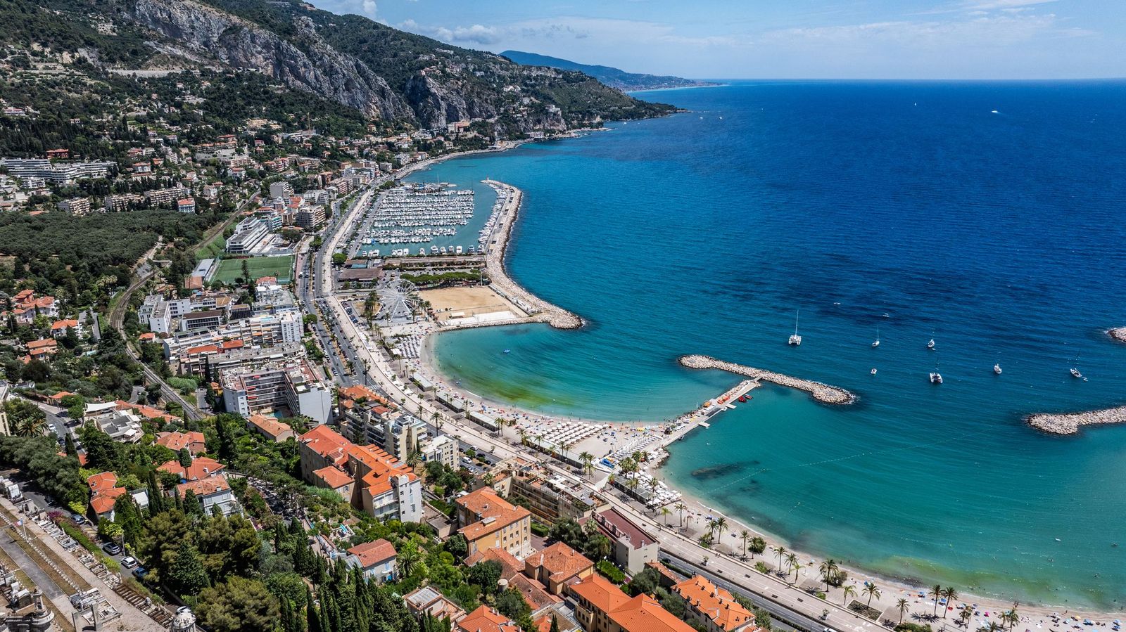 The coast east of Menton from the air, with the Plage des Sablettes and the port of Garavan