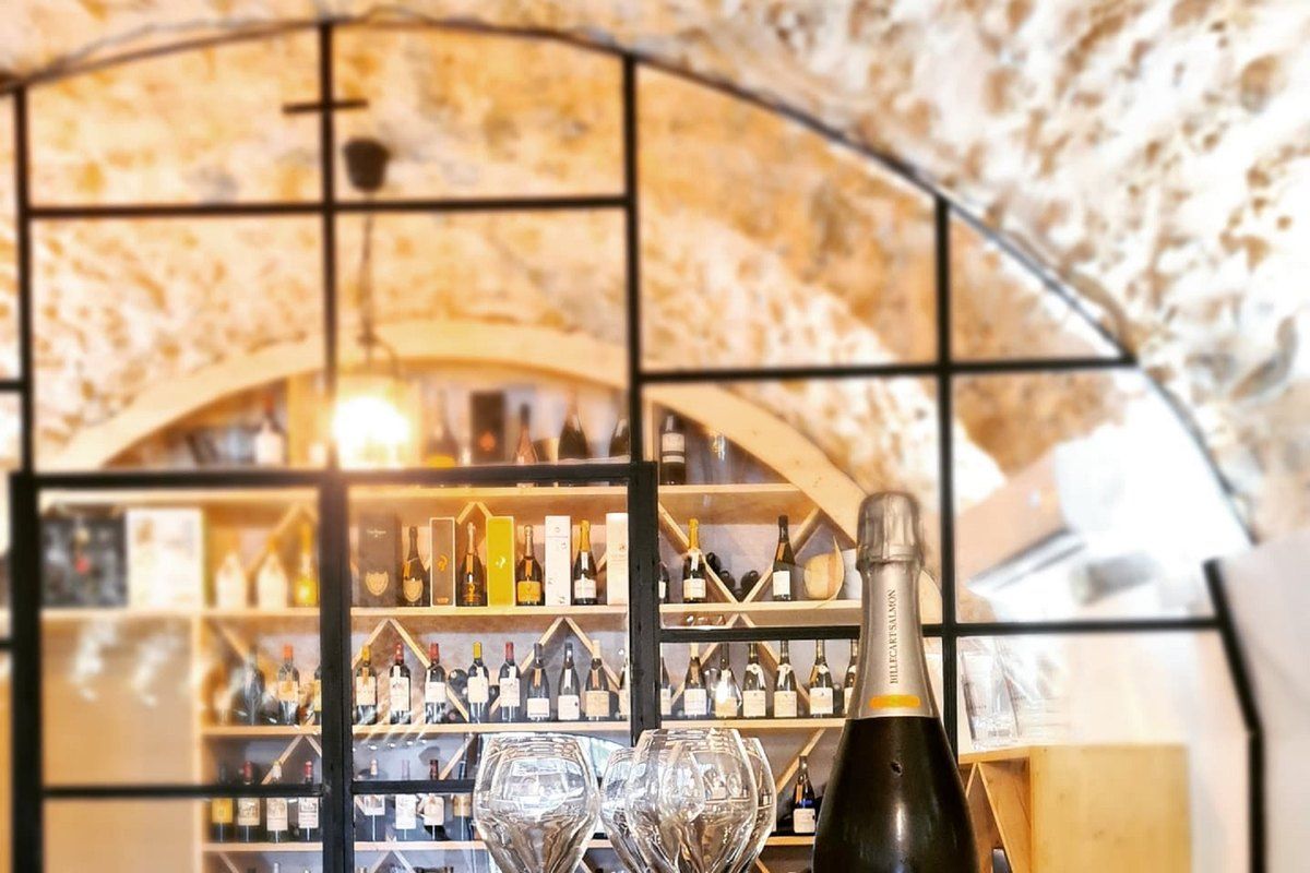 Wine shelves under the stone vault of Le Nabucco wine cellar and bar in Menton