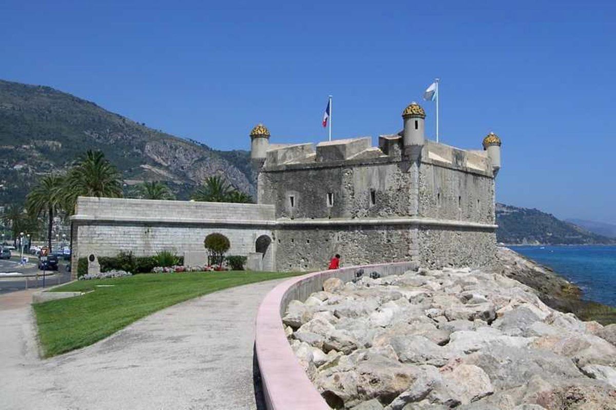 The 17th-century Bastion on Menton's old harbour, home of the Musée Jean Cocteau, with the coast behind