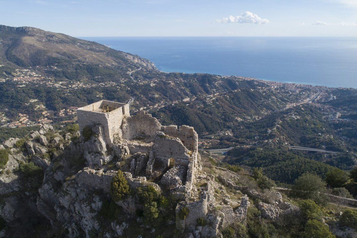 The ruined medieval castle of Sainte-Agnès on its rock, high above the coast and the sea
