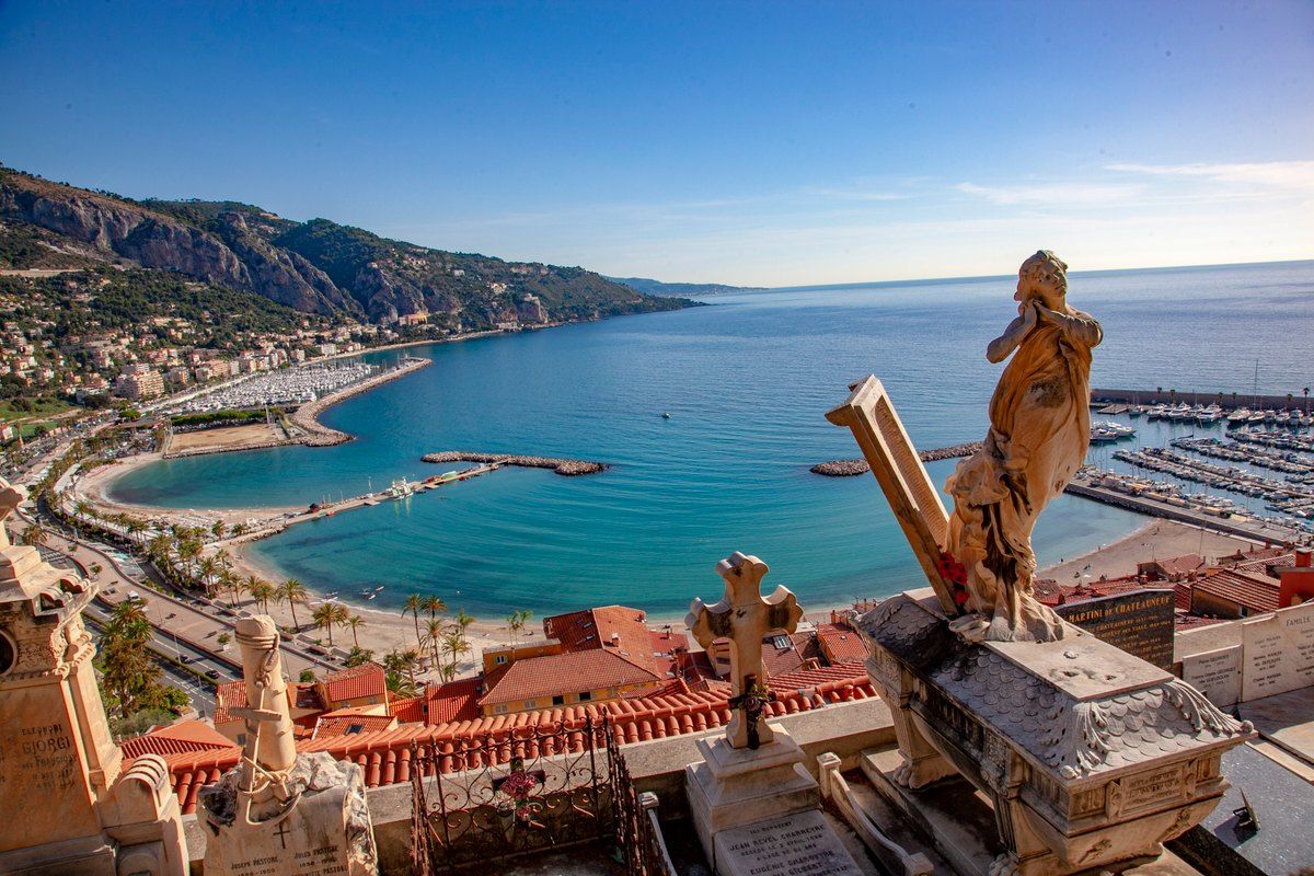 View from the Cimetière du Vieux-Château over Menton's rooftops, the old port and the bay towards Cap Martin