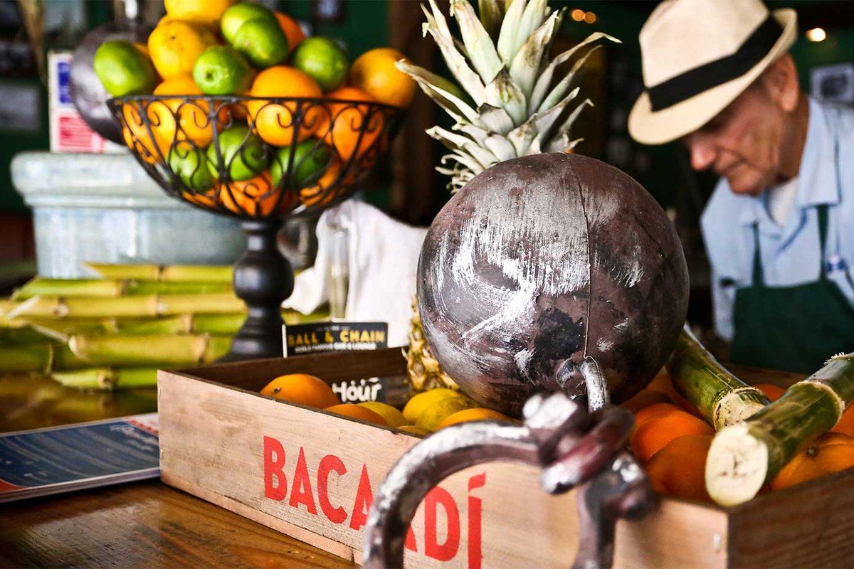 The bar at Ball & Chain on Calle Ocho, with a fruit basket, sugar cane and the iron ball and chain