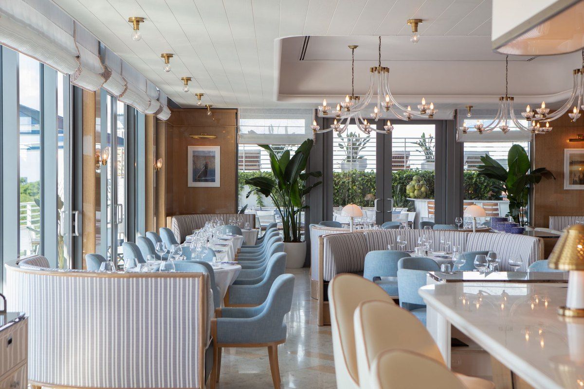 The pale blue and white dining room of Bellini on the rooftop of Mr. C Miami in Coconut Grove
