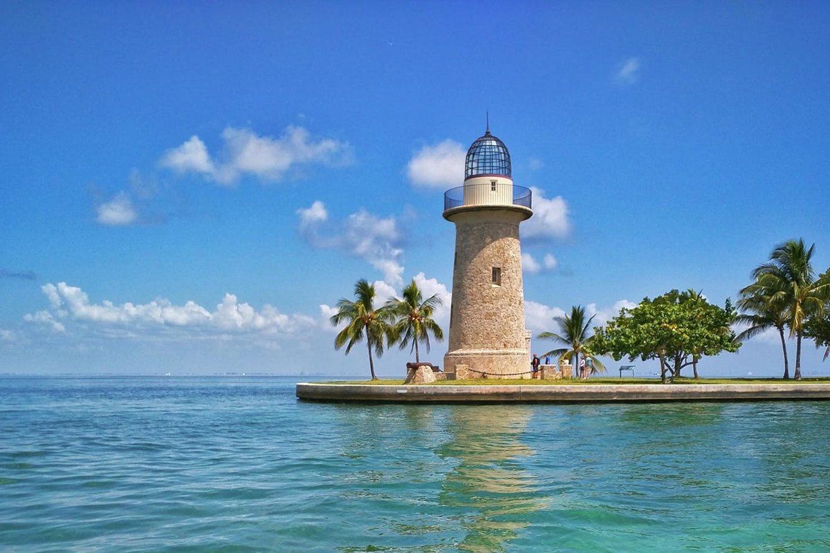 The stone lighthouse on Boca Chita Key in Biscayne National Park, with palms and turquoise water