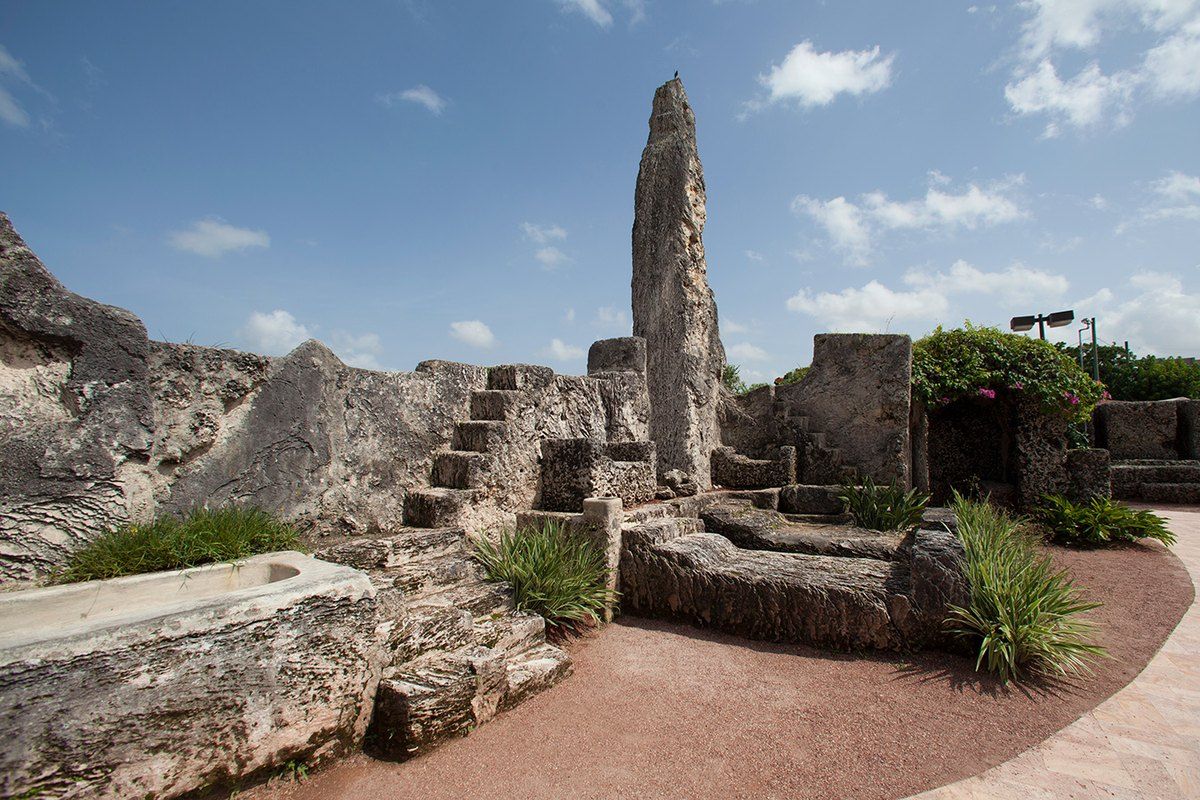 Carved coral-rock walls, steps and an obelisk in the sculpture garden of Coral Castle, Homestead