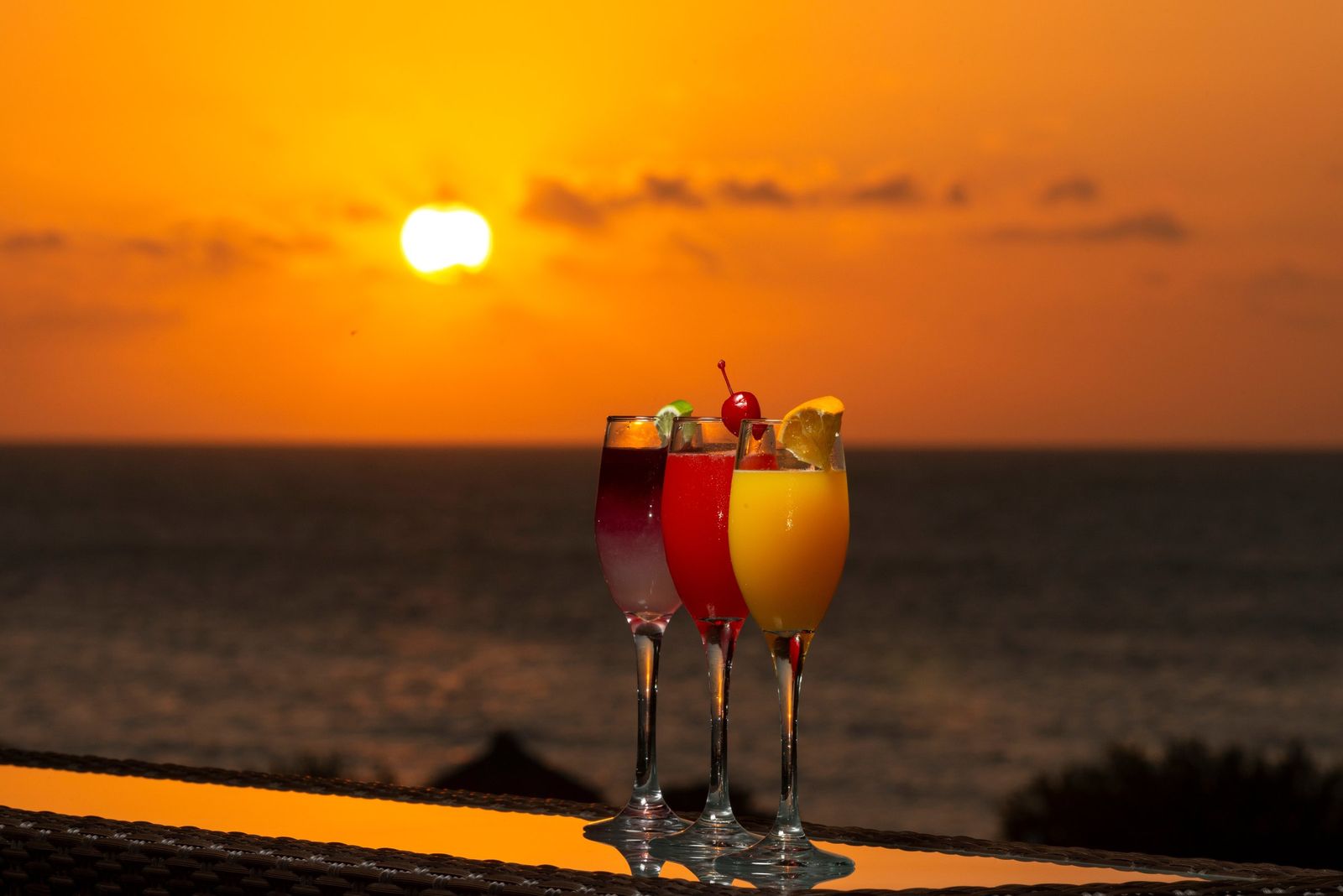 Tropical cocktails on a beachfront bar at sunset