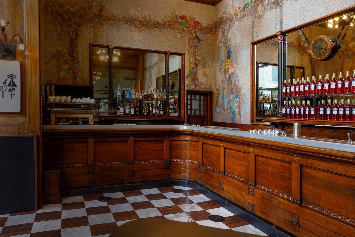 The wooden counter, mosaics and chequered floor of the Bar di Passo at Camparino in Galleria