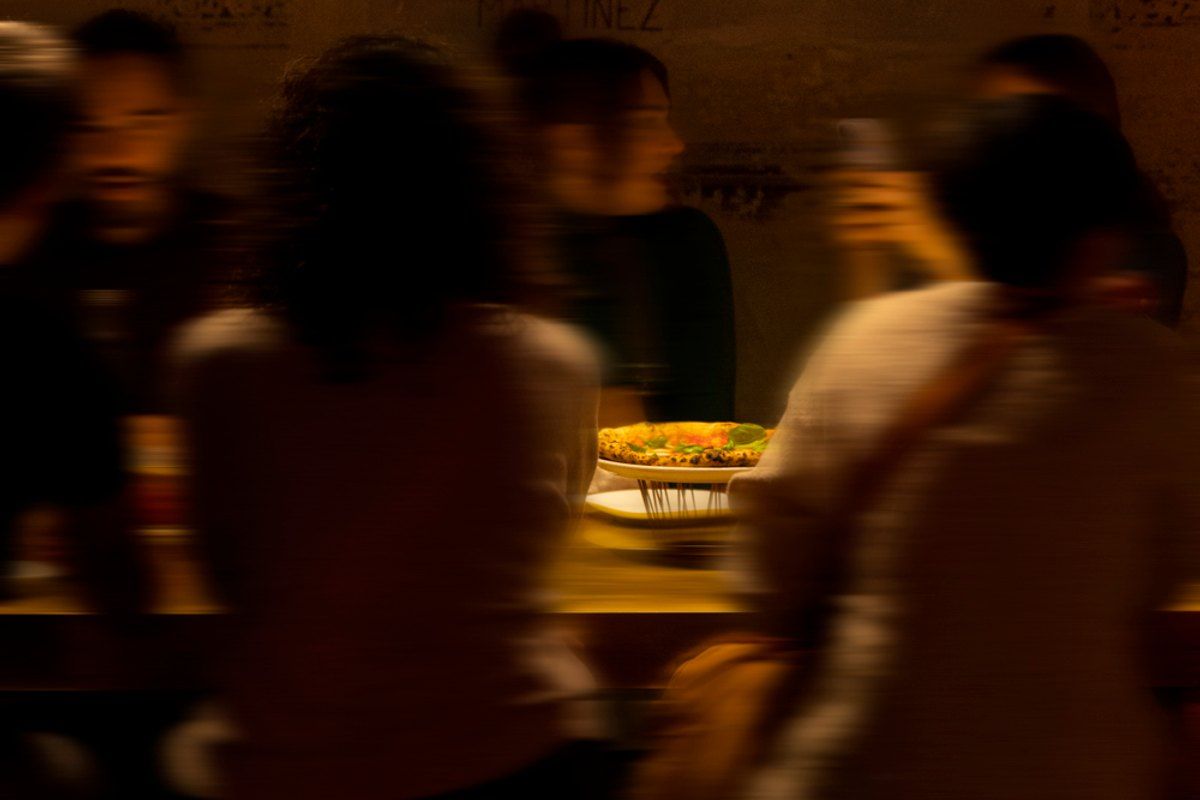 Guests at the bar in the warm evening light of Dry Milano, Via Solferino