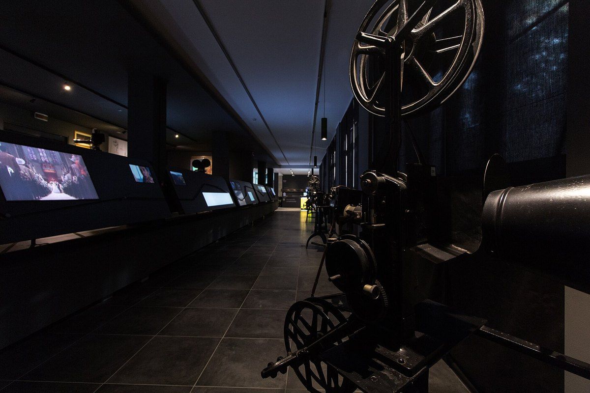 Vintage film projectors and interactive screens in the galleries of MIC – Museo Interattivo del Cinema, Milan