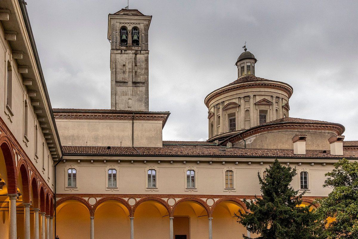 The Renaissance cloister of the Museo Nazionale della Scienza e della Tecnologia Leonardo da Vinci, with San Vittore's bell tower behind
