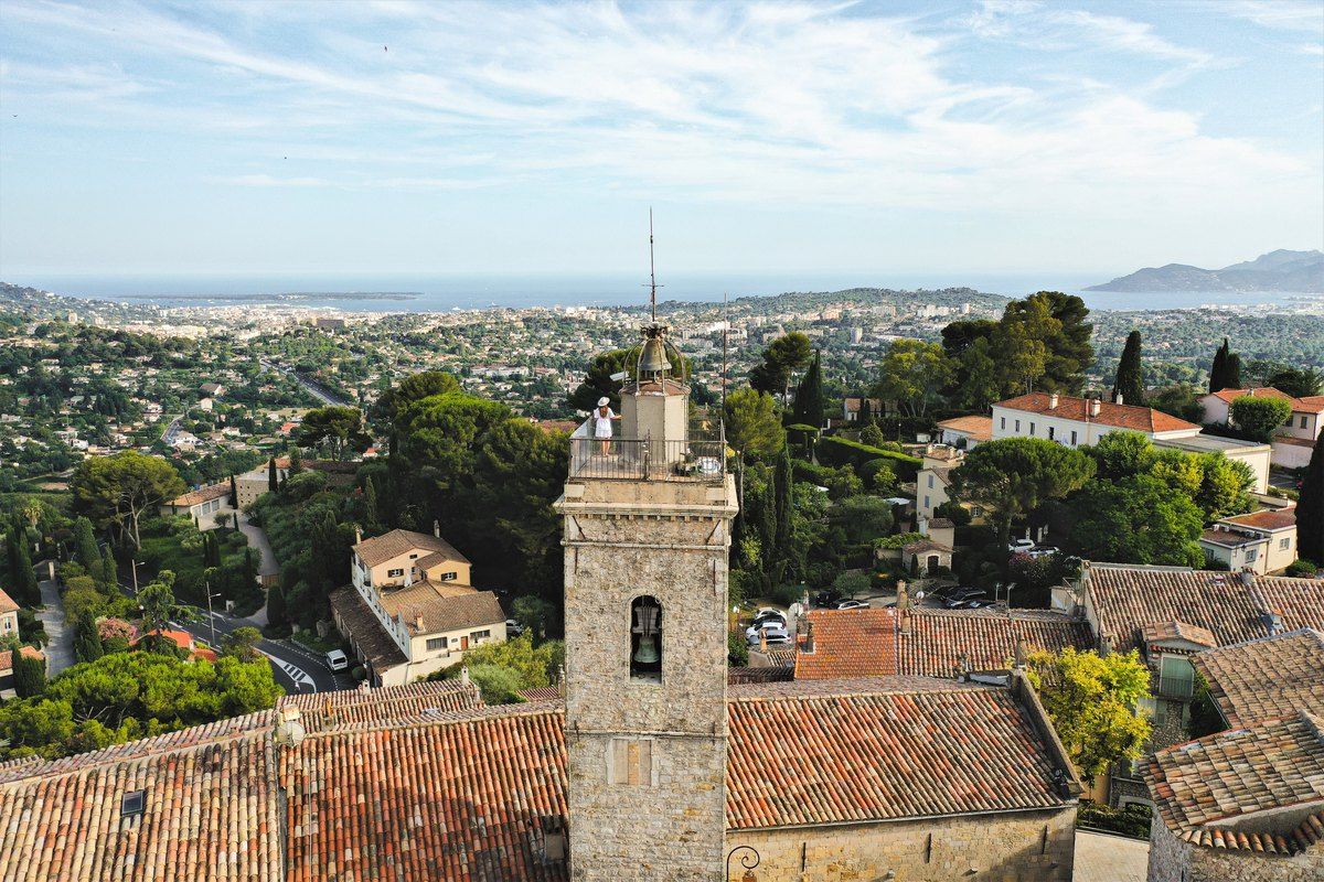 View from the bell tower of Saint-Jacques-le-Majeur over the rooftops of Mougins towards Cannes and the sea