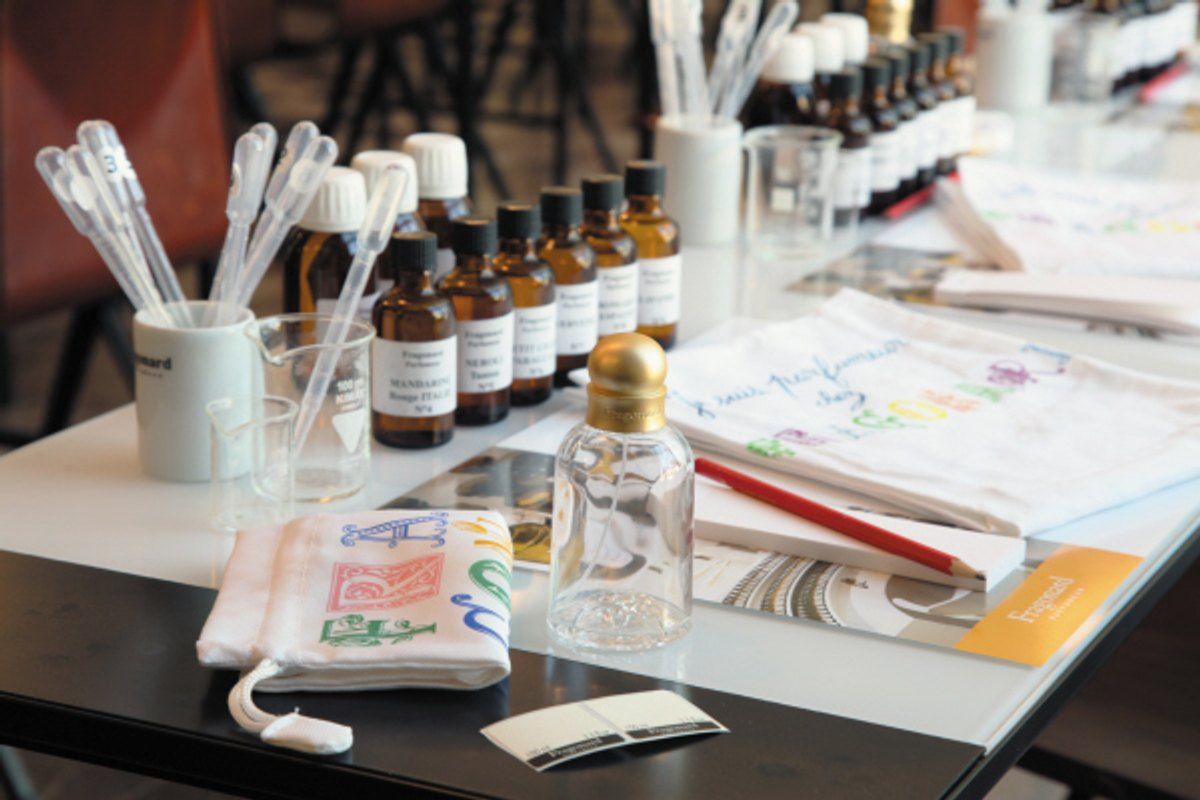 Bottles of essences, blotters and notes laid out for the Perfumer's Apprentice workshop at Fragonard