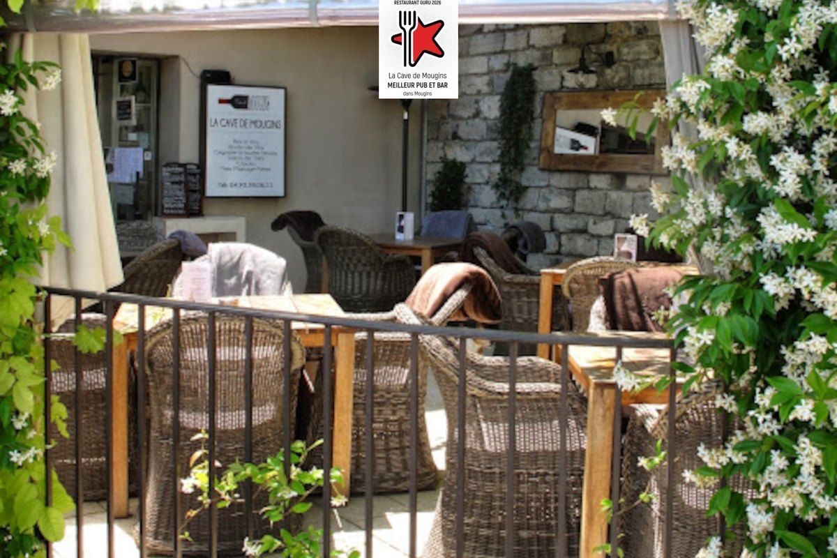 Wicker armchairs on the jasmine-framed terrace of La Cave de Mougins