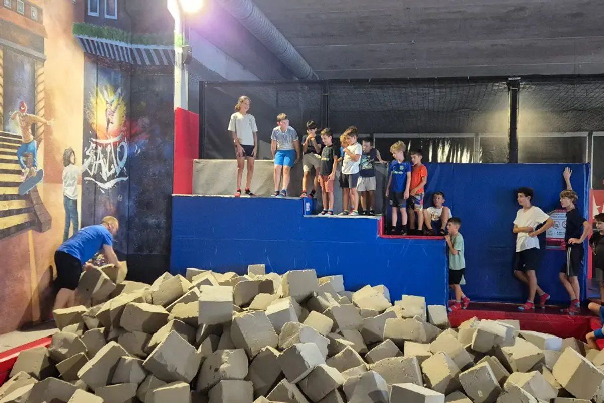 Children jumping on the trampolines and foam-block zone at Salto Trampoline Arena in Mougins