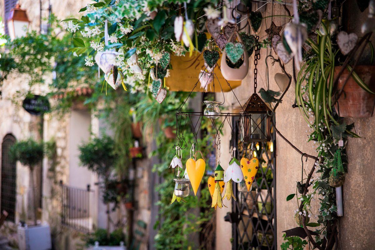 A narrow lane in Mougins old village hung with plants and decorations