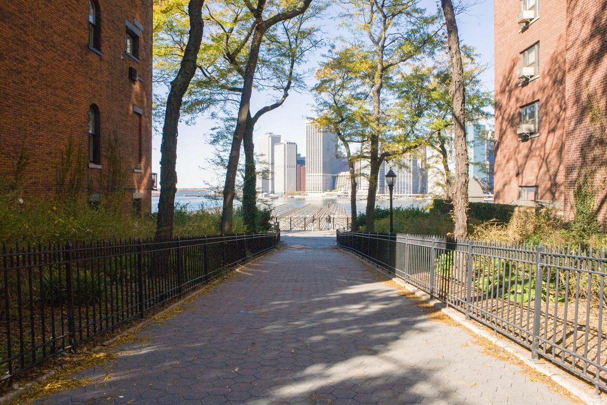 The Brooklyn Heights Promenade with the Lower Manhattan skyline at the end of the path