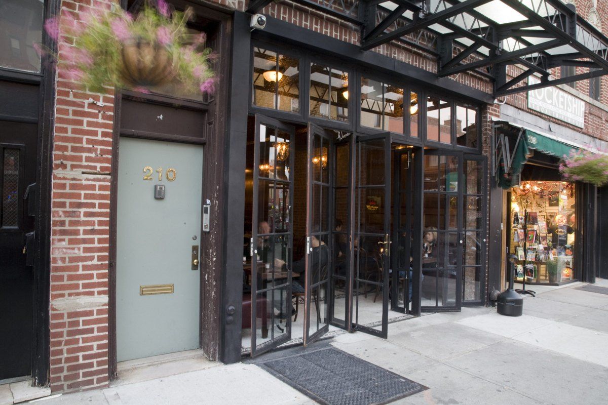 The brick front and glass doors of Clover Club on Smith Street, Cobble Hill